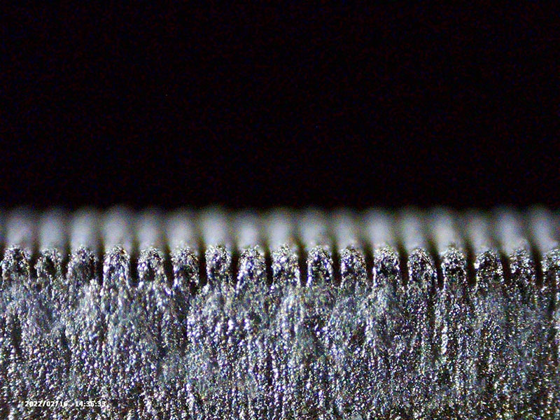 Microscopic view of a laser-textured metal surface.