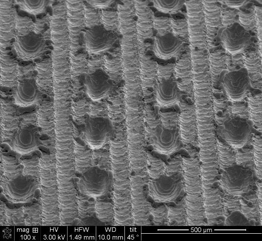 SEM image of laser textured aluminum surface (dimple pattern)