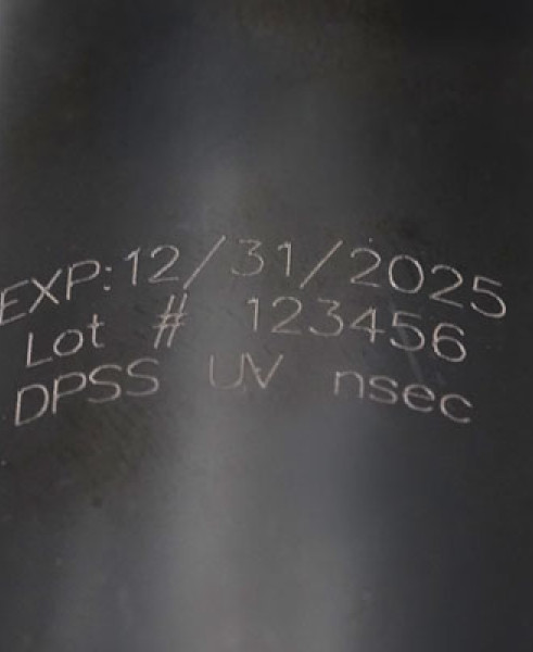 White laser marking on black plastic bottle